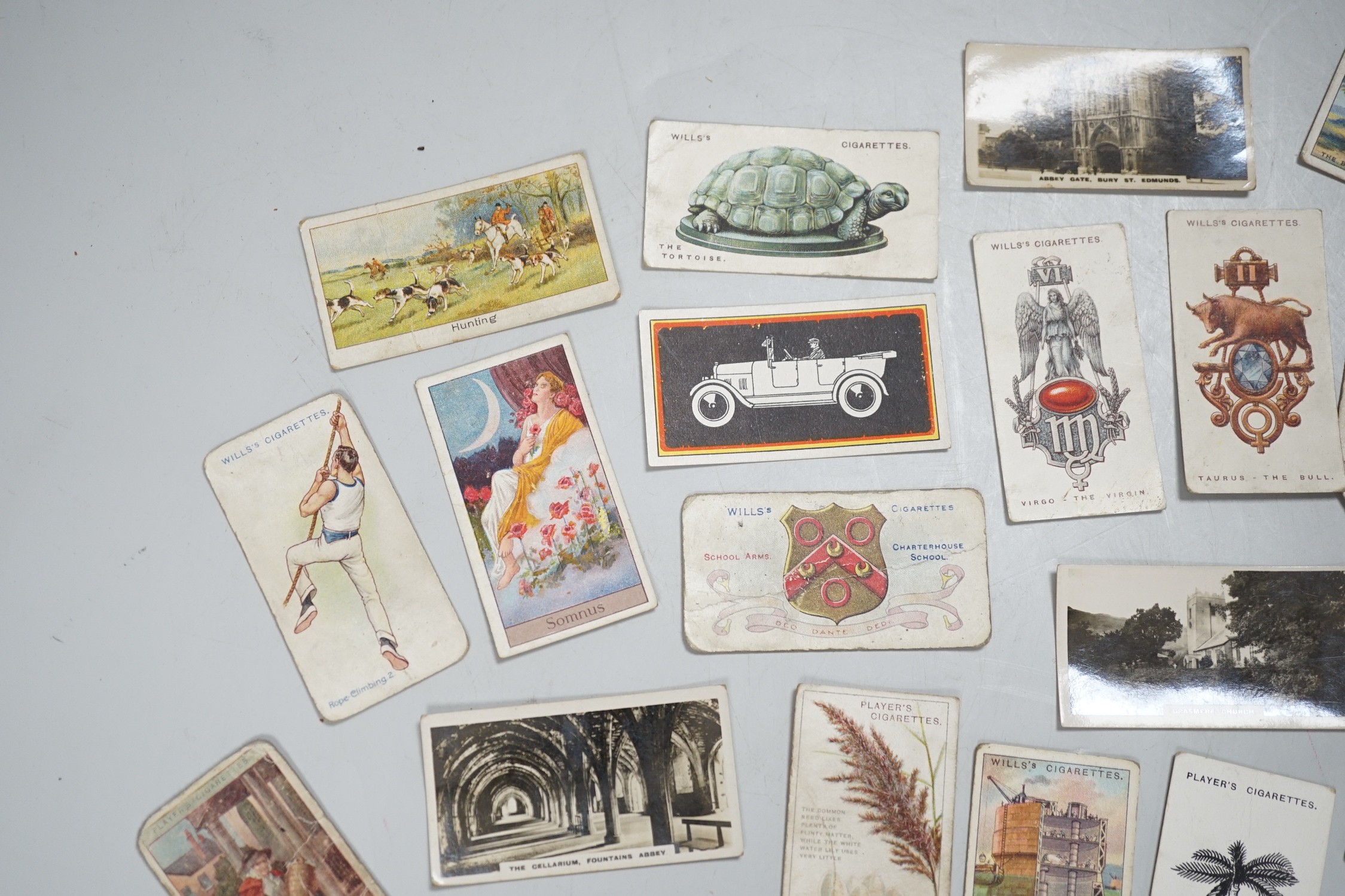 A large collection of mounted and loose cigarette cards